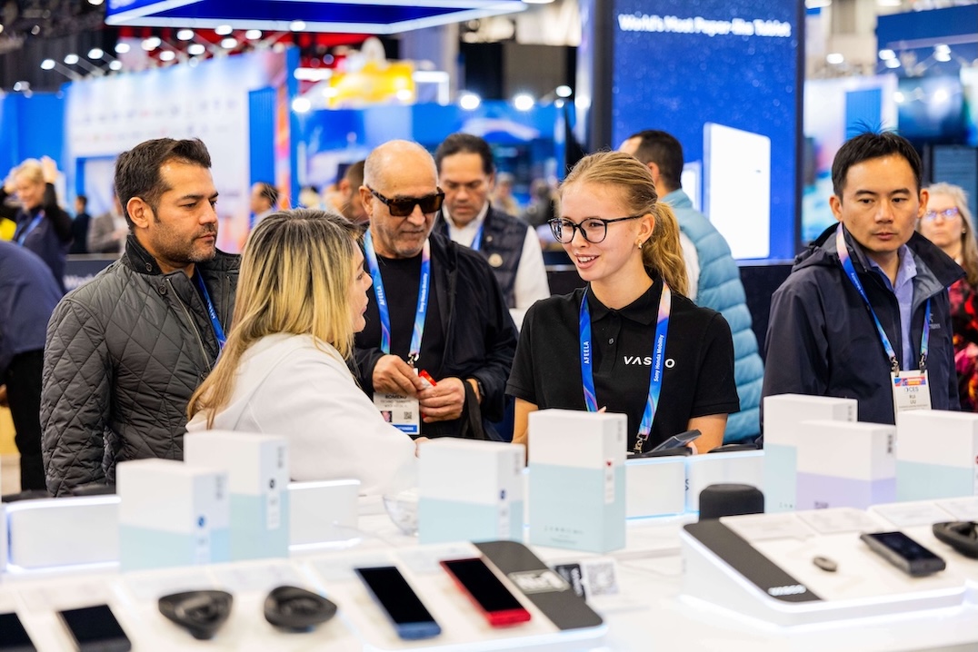 CES 2026 Mosolygós emberek beszélgetnek a Vasco Electronics standján a CES 2026 kiállításon.